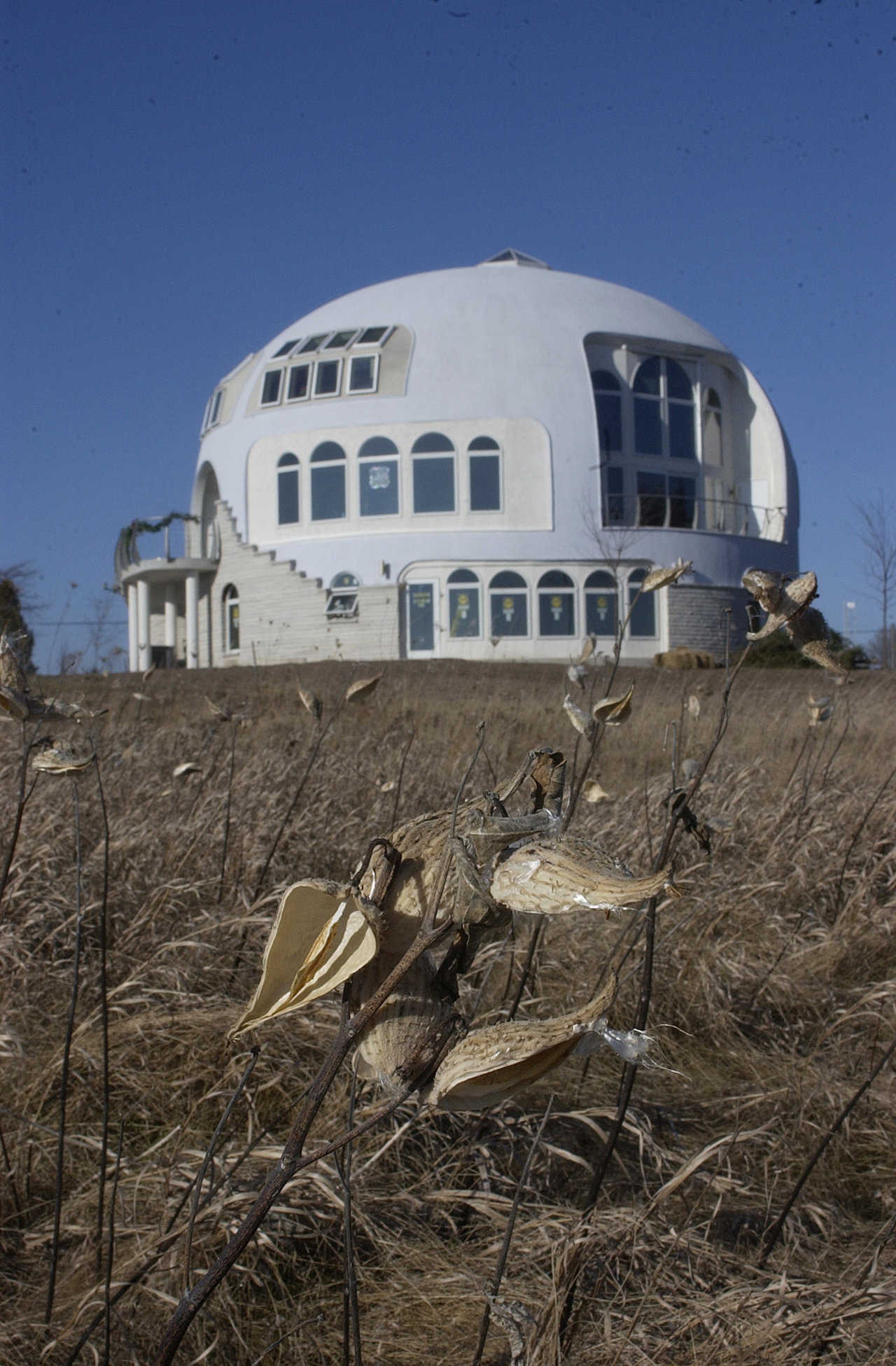 The Disappearing Dome — This a Monolithic Dome with a diameter of 55 feet and three stories.  The Disappearing Dome overlooks Lake Michigan.