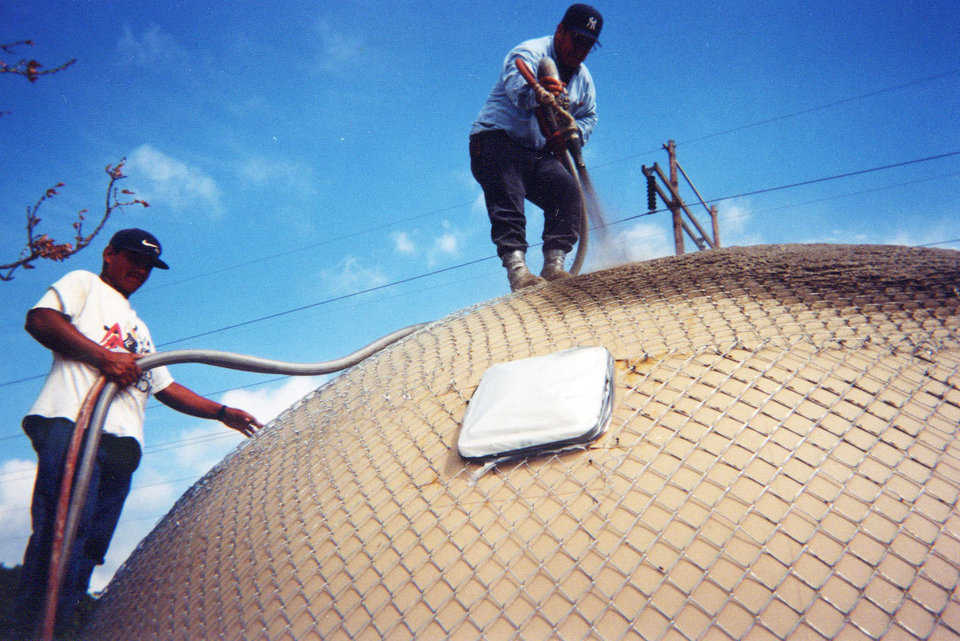 Applying Shotcrete — Javier and another Monolithic crew member are applying the first layer of shotcrete to the exterior of the dome. This layer will be followed with two more, much thinner, layers.